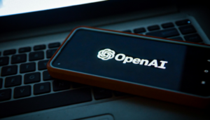 picture of a phone with open ai on a laptop with dark background